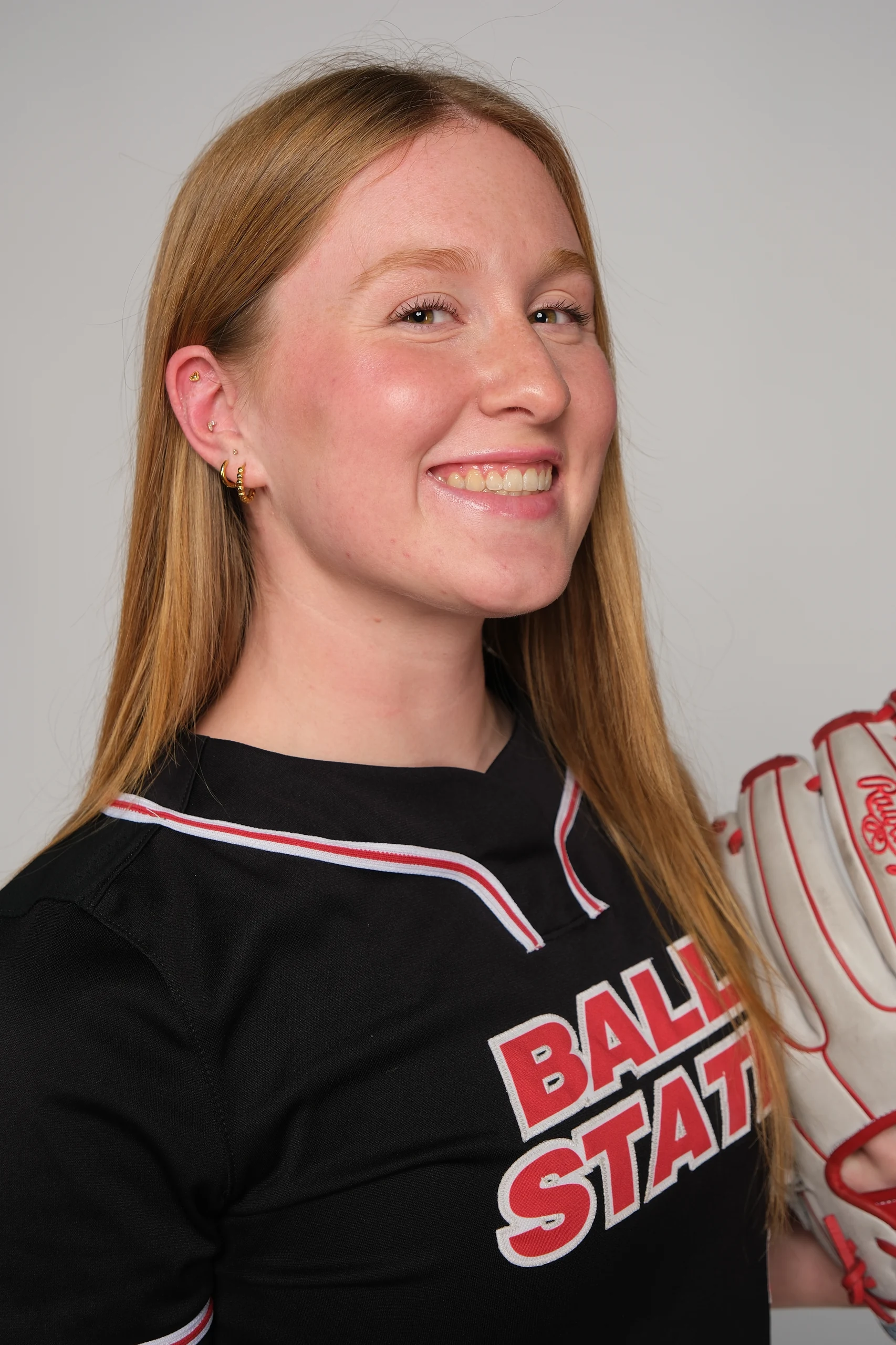 Maia Pietrzak in her Ball State softball jersey holding her glove
